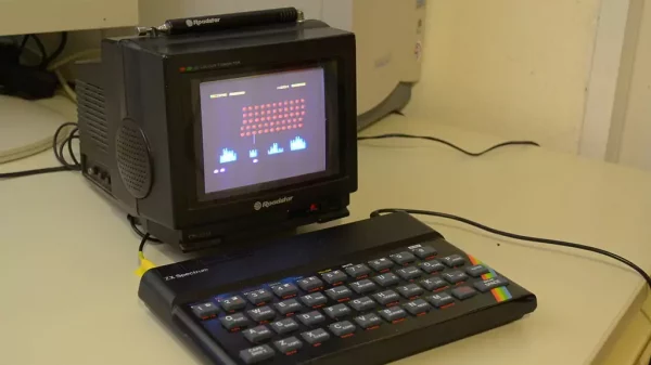 ZX Spectrum Computer and Roadster TV Sitting on a Table.